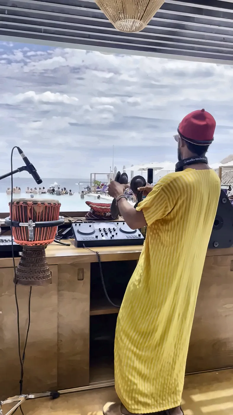 Taïb playing above a pool full of people