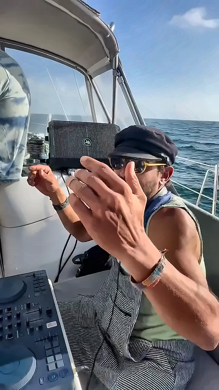 Taïb playing a set on a sailboat at sea